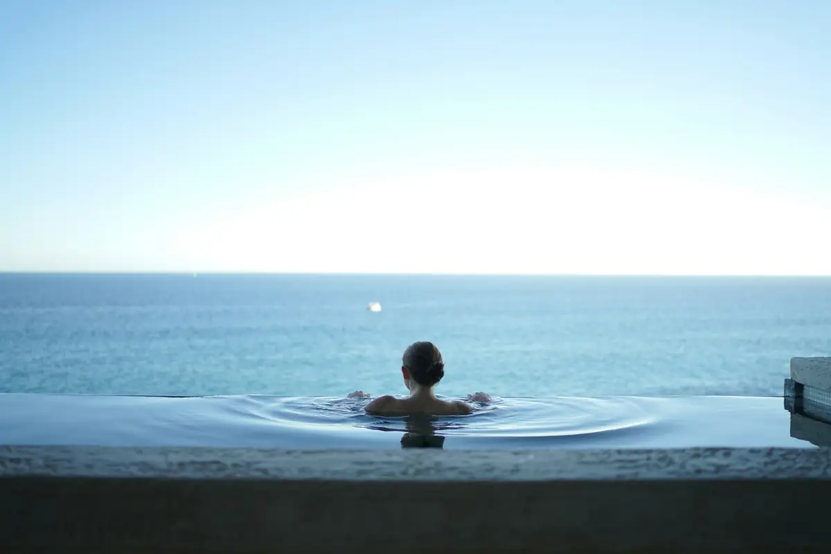 Person swimming in a calm infinity pool
